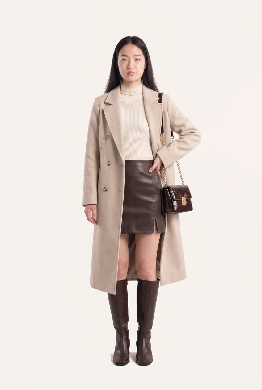 The same outfit rendered on a model: the coat, turtleneck, skirt, boots and bag together